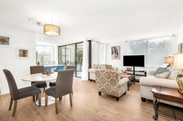 a living room with furniture wooden floor and a flat screen tv