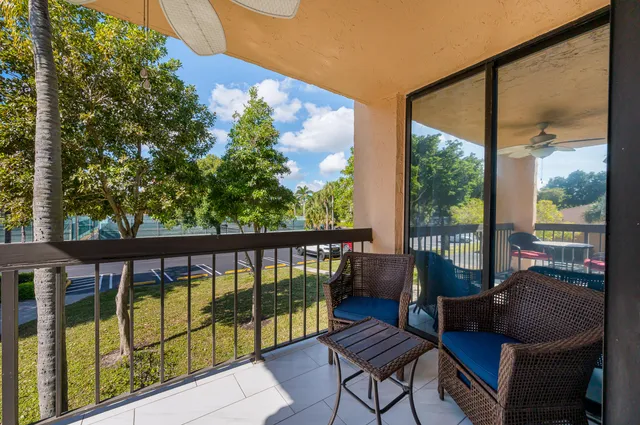 a view of a two chairs in the balcony