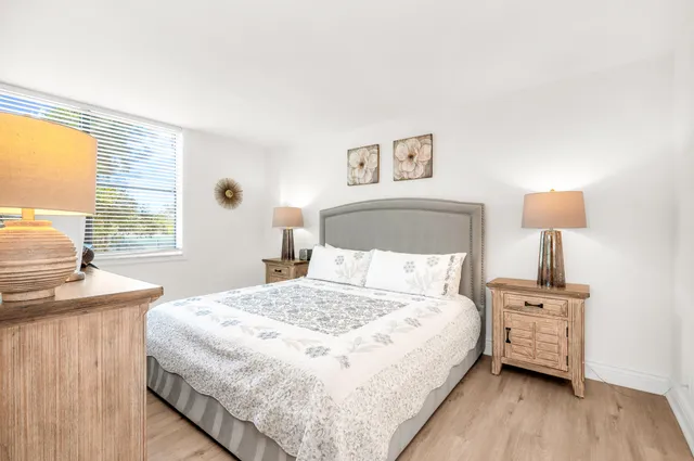 a bedroom with a bed and a night stand