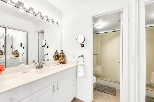 a bathroom with a shower sink and mirror