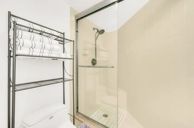 a bathroom with a glass shower door