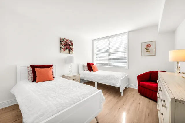 a bedroom with two beds and a couch