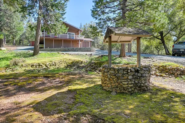 a front view of a house with a yard and shrubs