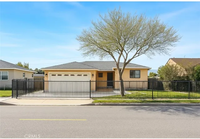 a view of a house with a big yard and large trees