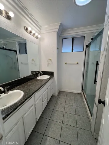 an empty room with windows and chandelier fan