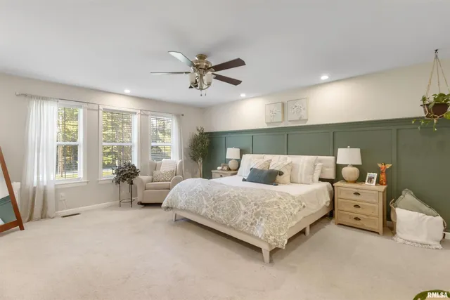 a spacious bedroom with a bed and large windows