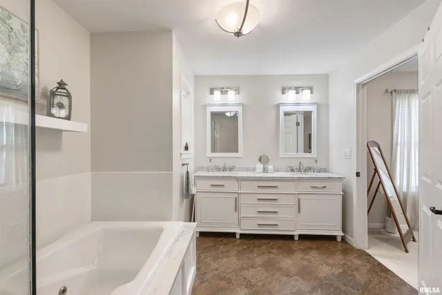 a bathroom with a bathtub sink and mirror