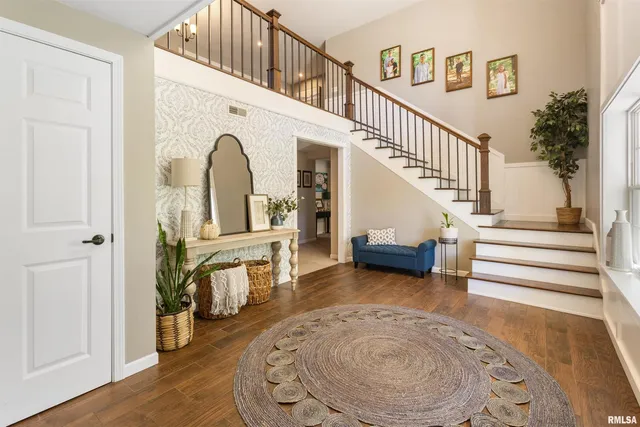 a view of entryway and hall with wooden floor