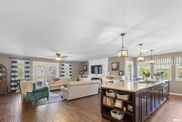 a kitchen with stainless steel appliances granite countertop a lot of counter space and wooden floor
