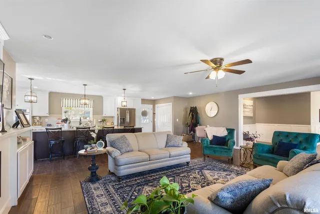 a living room with furniture ceiling fan and a rug