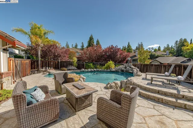 a swimming pool with wooden fence