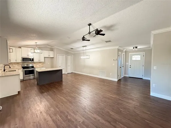 a view of kitchen with cabinets and wooden floor
