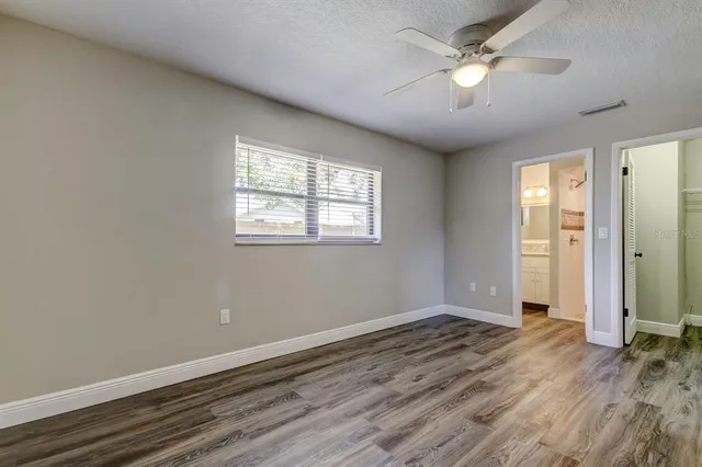 wooden floor in an empty room with a window