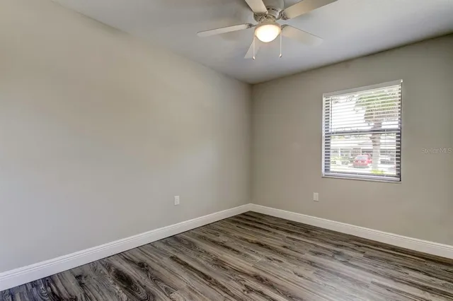 a view of an empty room with wooden floor