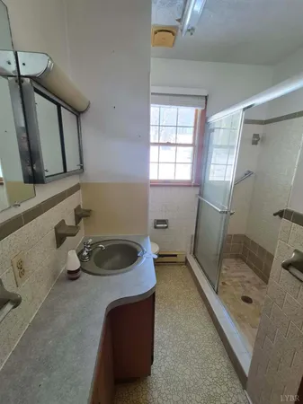 a bathroom with a tub sink and mirror