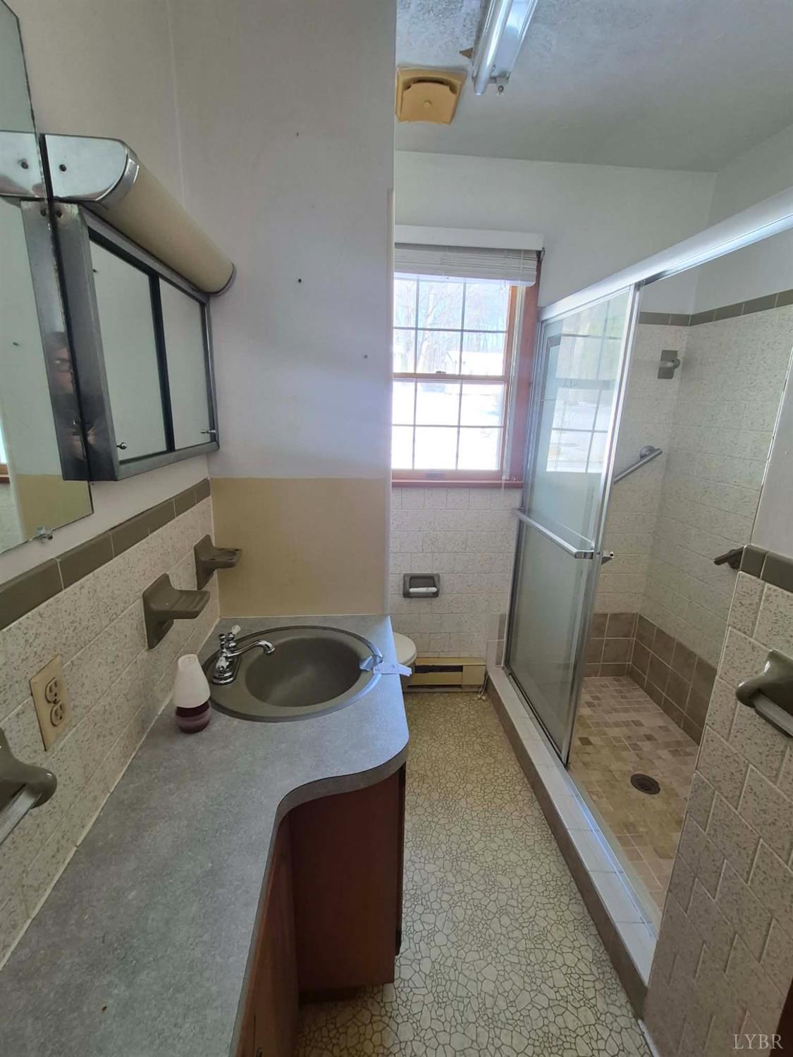 123 Elmwood Lane Rustburg, VA 24588 - Photo 21 of 25 a bathroom with a tub sink and mirror