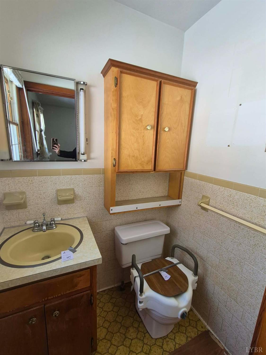 123 Elmwood Lane Rustburg, VA 24588 - Photo 22 of 25 a bathroom with a toilet a sink and mirror