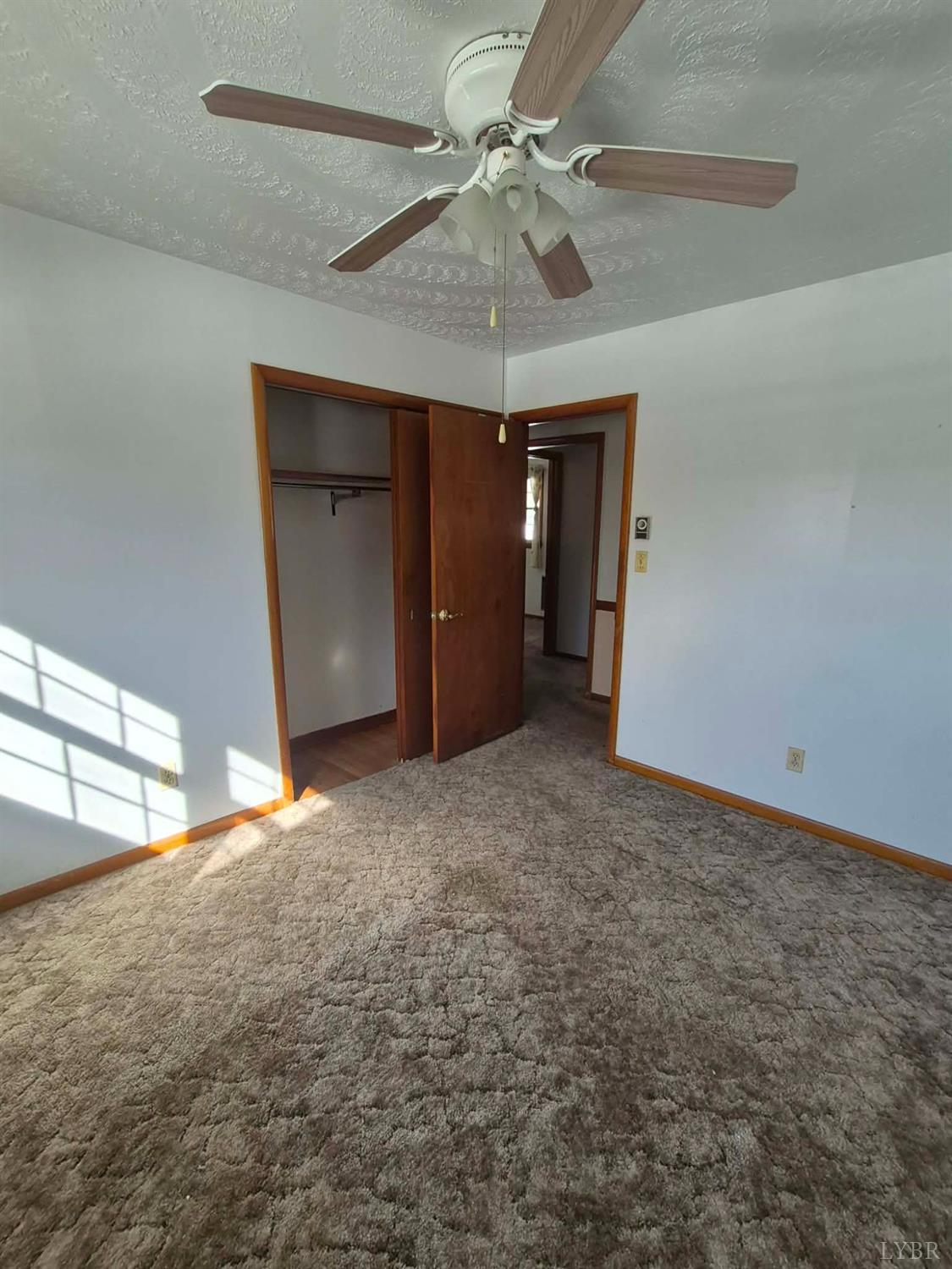 123 Elmwood Lane Rustburg, VA 24588 - Photo 23 of 25 en empty room with windows and fan