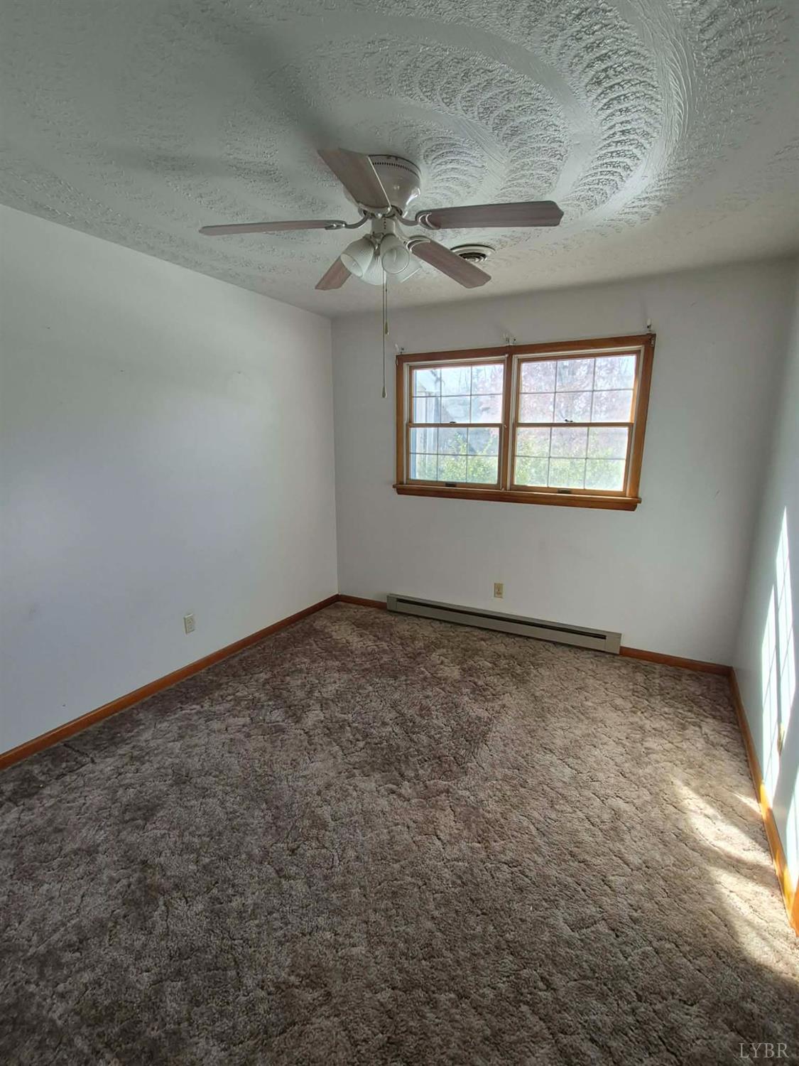 123 Elmwood Lane Rustburg, VA 24588 - Photo 24 of 25 an empty room with a ceiling fan and window