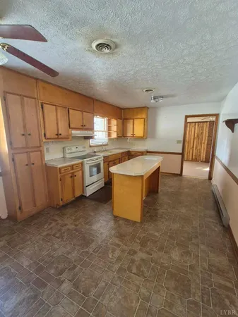 a large kitchen with a stove top oven sink and cabinets