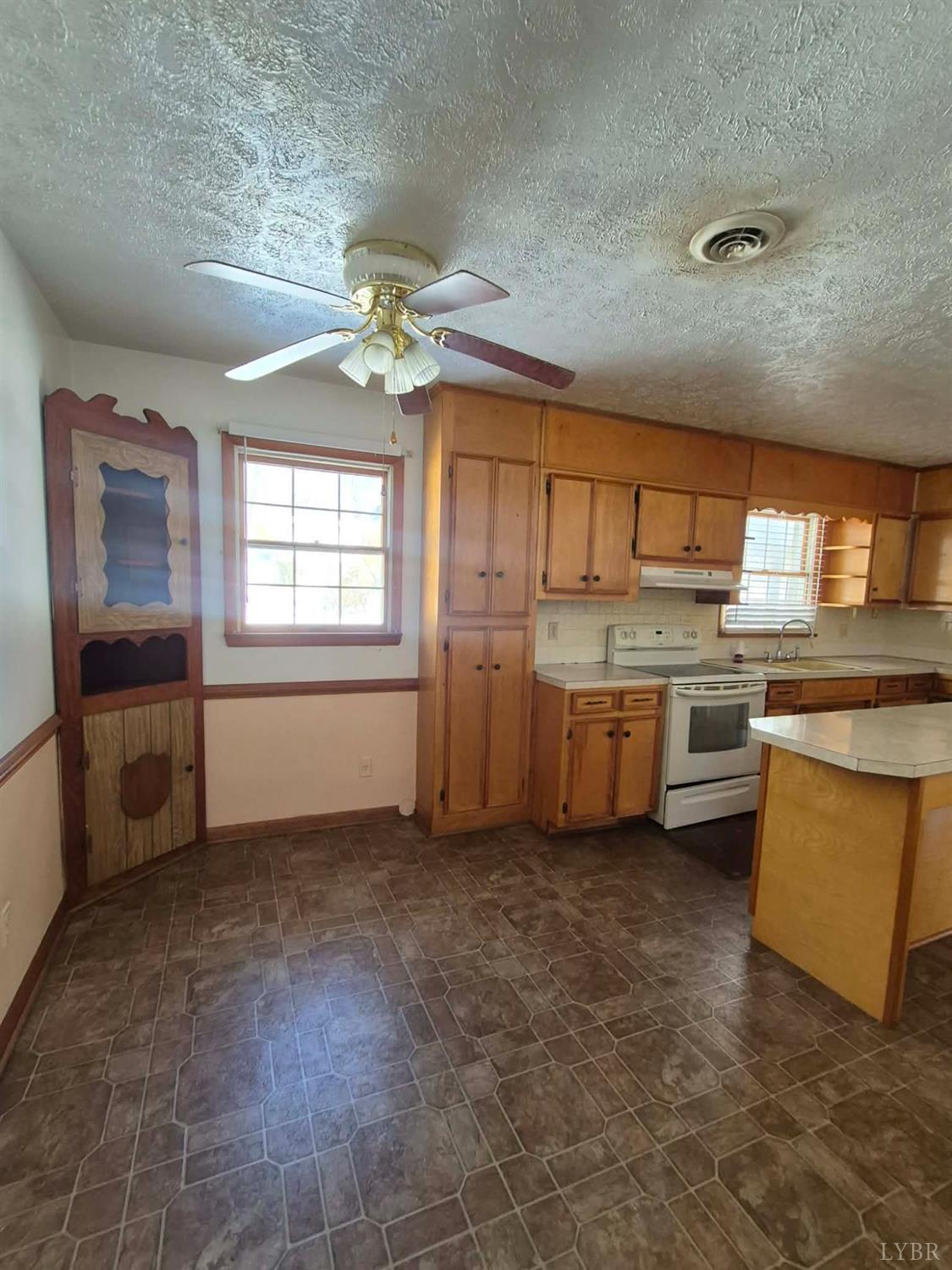 123 Elmwood Lane Rustburg, VA 24588 - Photo 6 of 25 a kitchen with stainless steel appliances granite countertop a stove a sink and a refrigerator