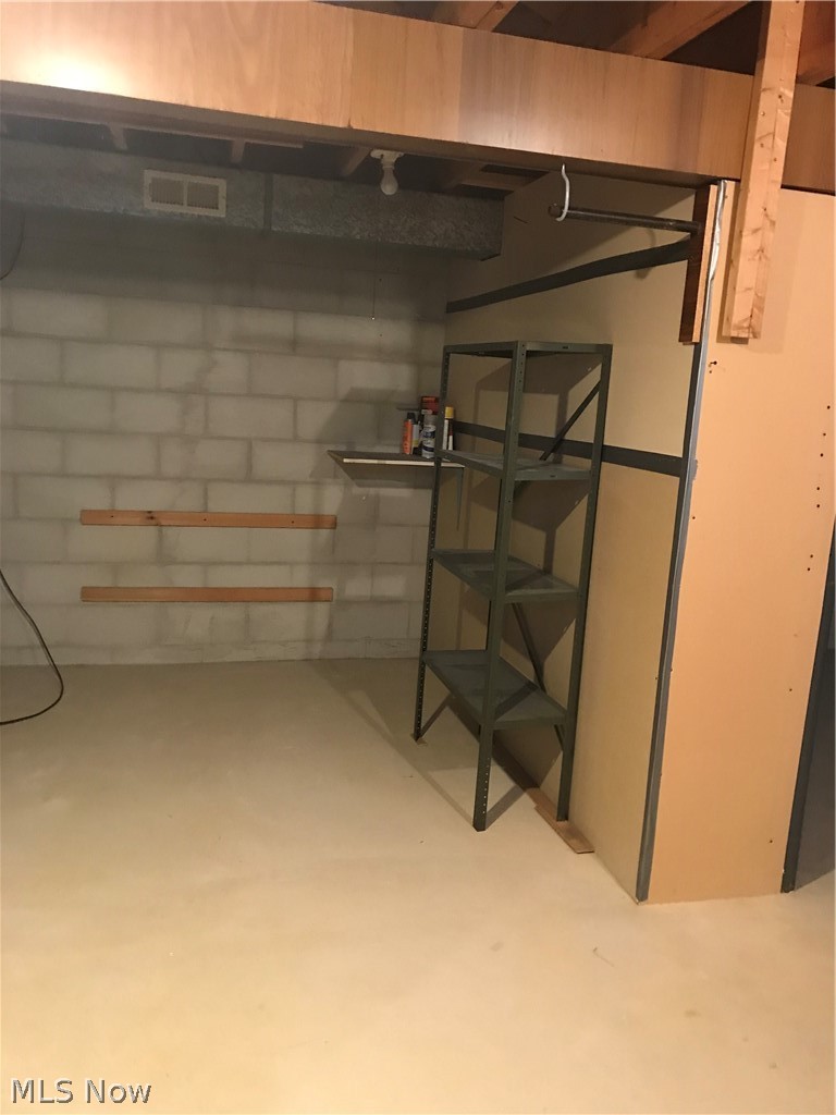 4895 4th Street Northwest Canton, OH 44708 - Photo 24 of 31 Basement storage area and workshop on the other side of wall.