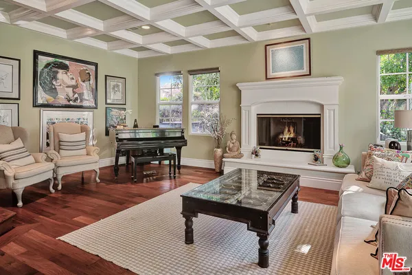 a living room with furniture a table and a fireplace