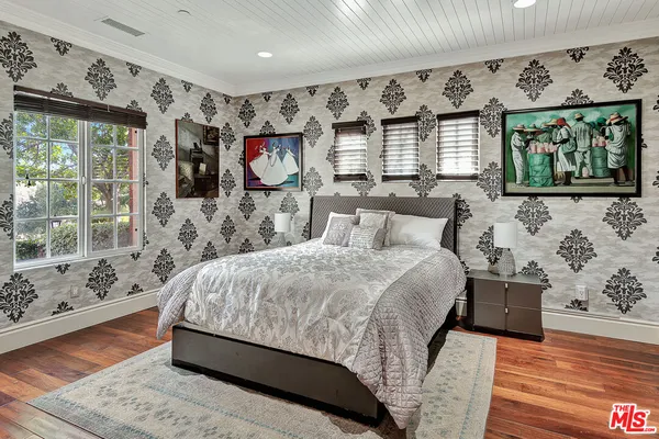 a bedroom with a large bed and a window