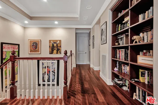 a view of a hallway with wooden floor and closet