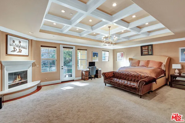 a spacious bedroom with a bed and a fireplace