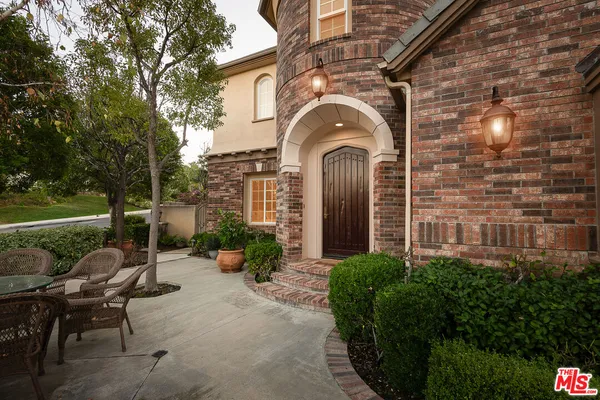 a front view of a house with garden and porch