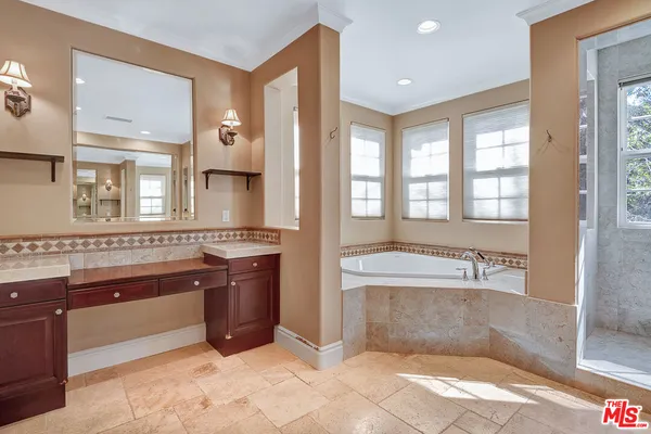 a large bathroom with a large tub and sink
