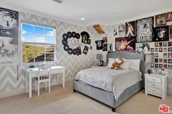 a bedroom with a bed and a table in it