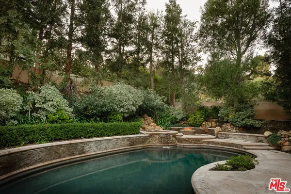 a view of swimming pool from a yard