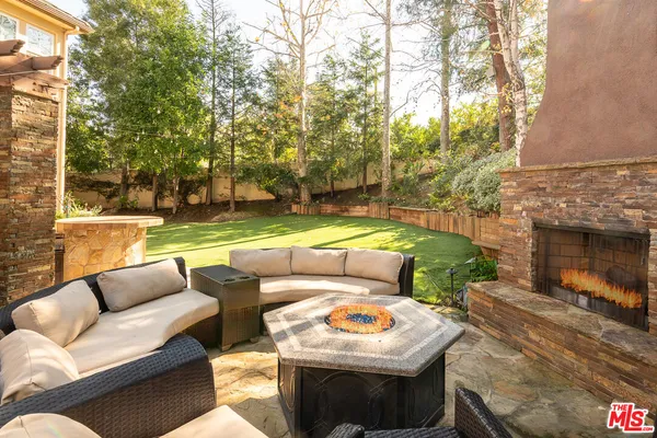 a view of a patio with couches and a fire pit