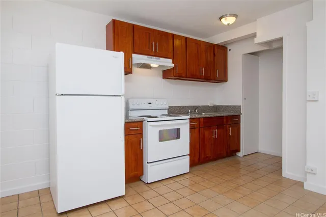 a white refrigerator freezer sitting inside of a kitchen