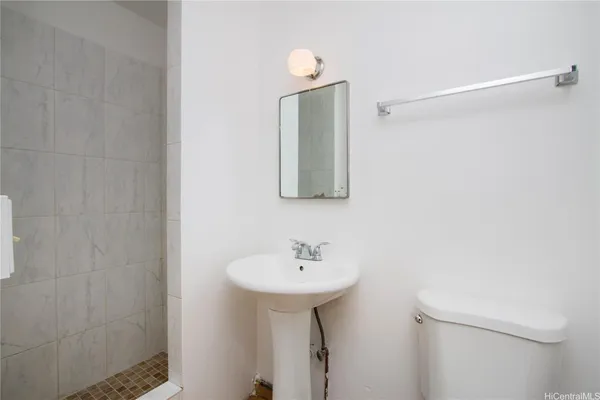 a bathroom with a sink a light fixture and a mirror