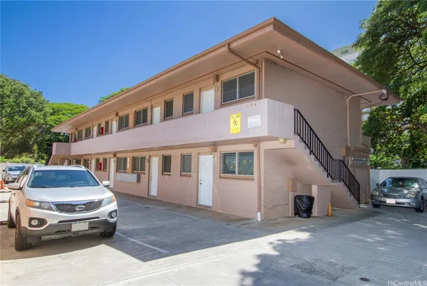 a front view of a house with parking space