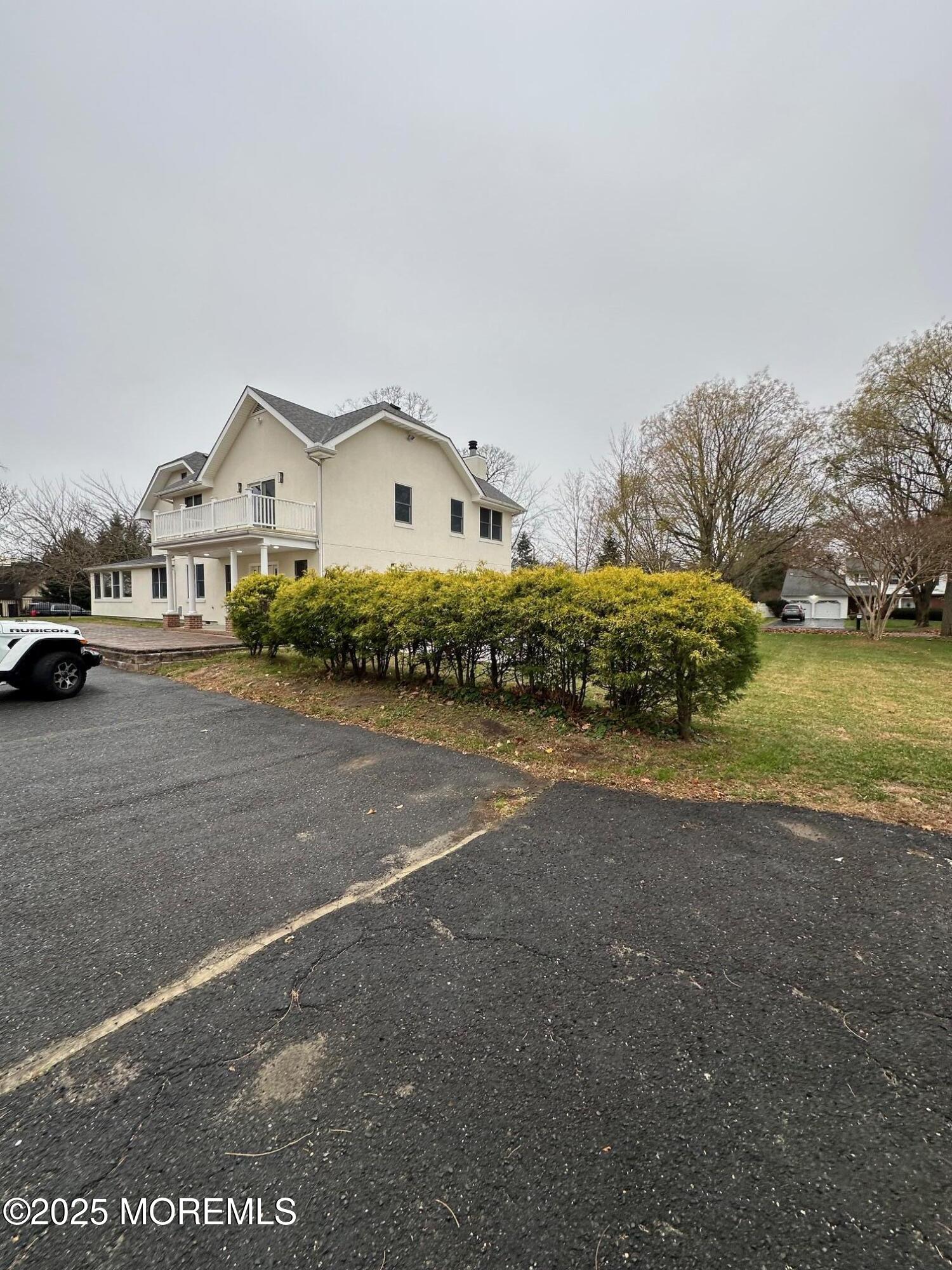 469 Wall Street Eatontown, NJ 07724 - Photo 16 of 17 a front view of a house with a yard and garage