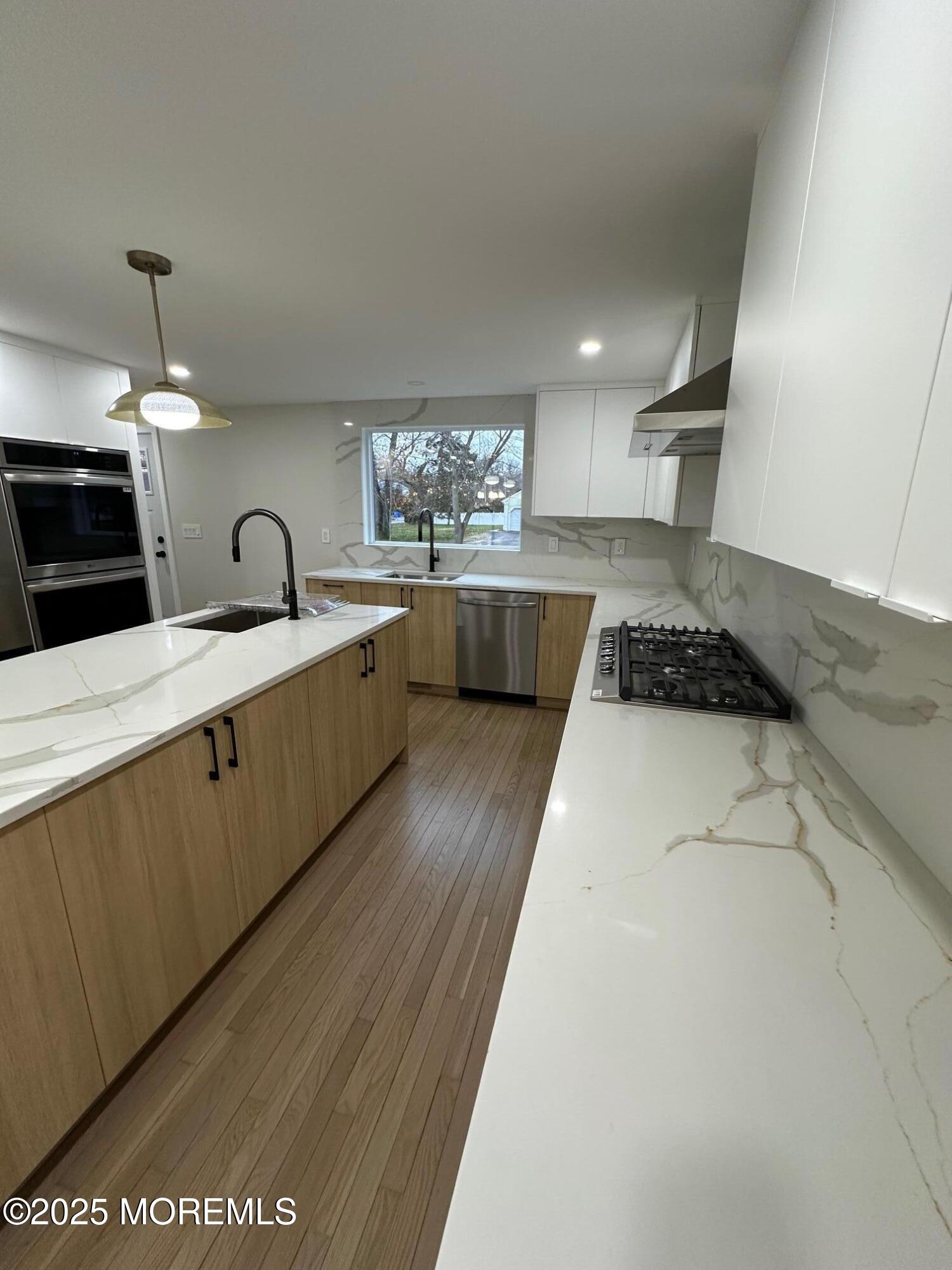 469 Wall Street Eatontown, NJ 07724 - Photo 6 of 17 a kitchen with stainless steel appliances granite countertop a sink a stove top oven a counter space and cabinets