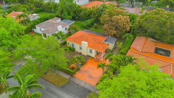 an aerial view of a house with garden space and street view