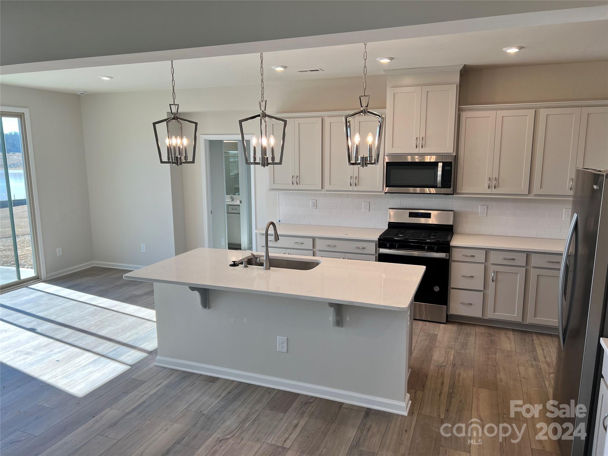 2541 Crimson Way Monroe, NC 28112 - Photo 1 of 22 a kitchen with stainless steel appliances kitchen island a sink a stove a refrigerator and cabinets
