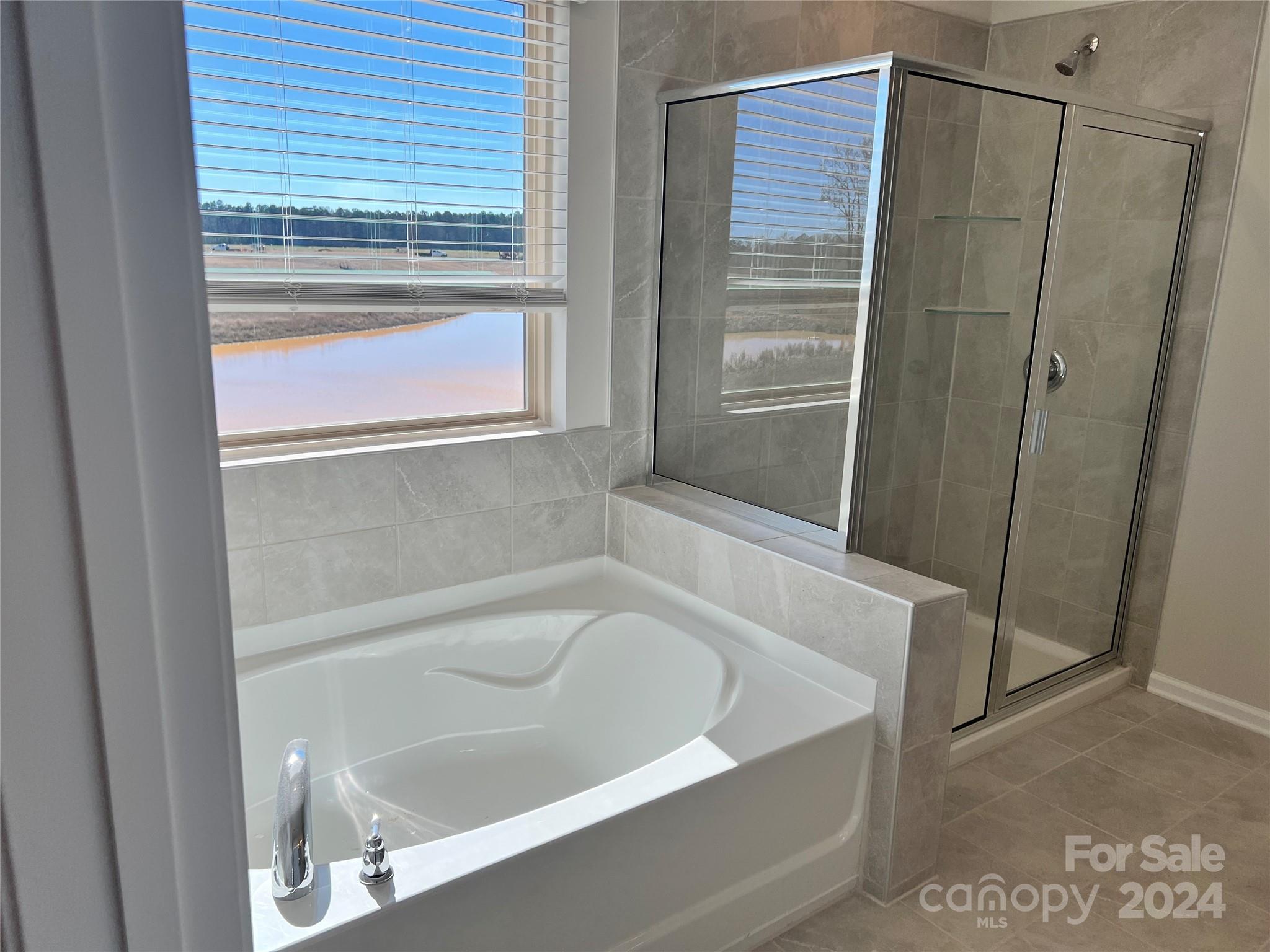 2541 Crimson Way Monroe, NC 28112 - Photo 14 of 22 a white bath tub sitting next to a shower