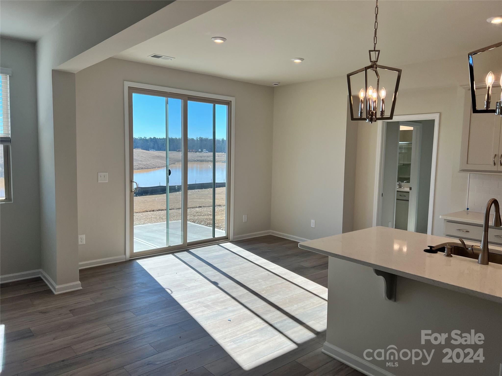 2541 Crimson Way Monroe, NC 28112 - Photo 3 of 22 a view of counter top space and bedroom with wooden floor