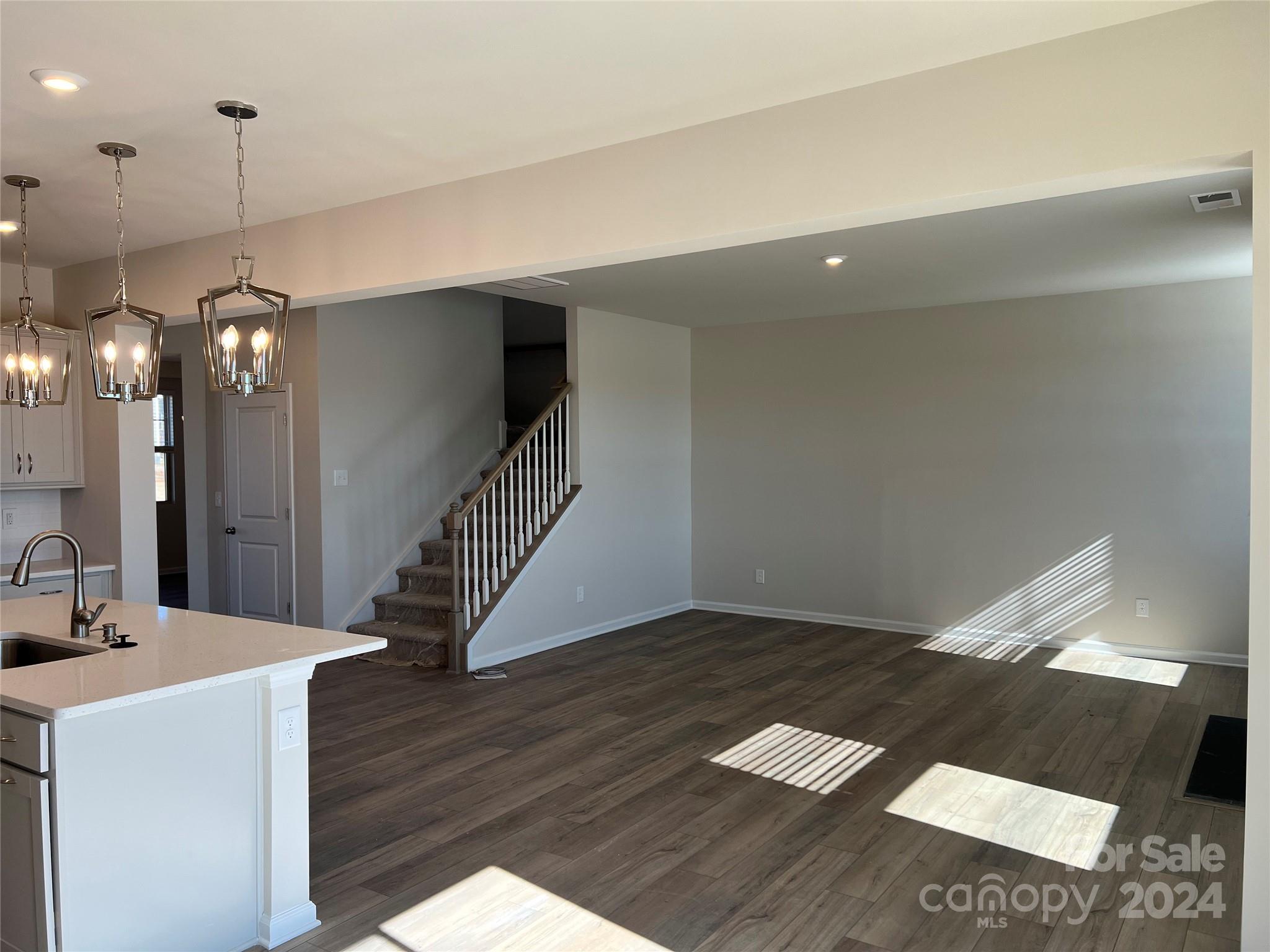 2541 Crimson Way Monroe, NC 28112 - Photo 5 of 22 a view of a hallway with wooden floor and staircase