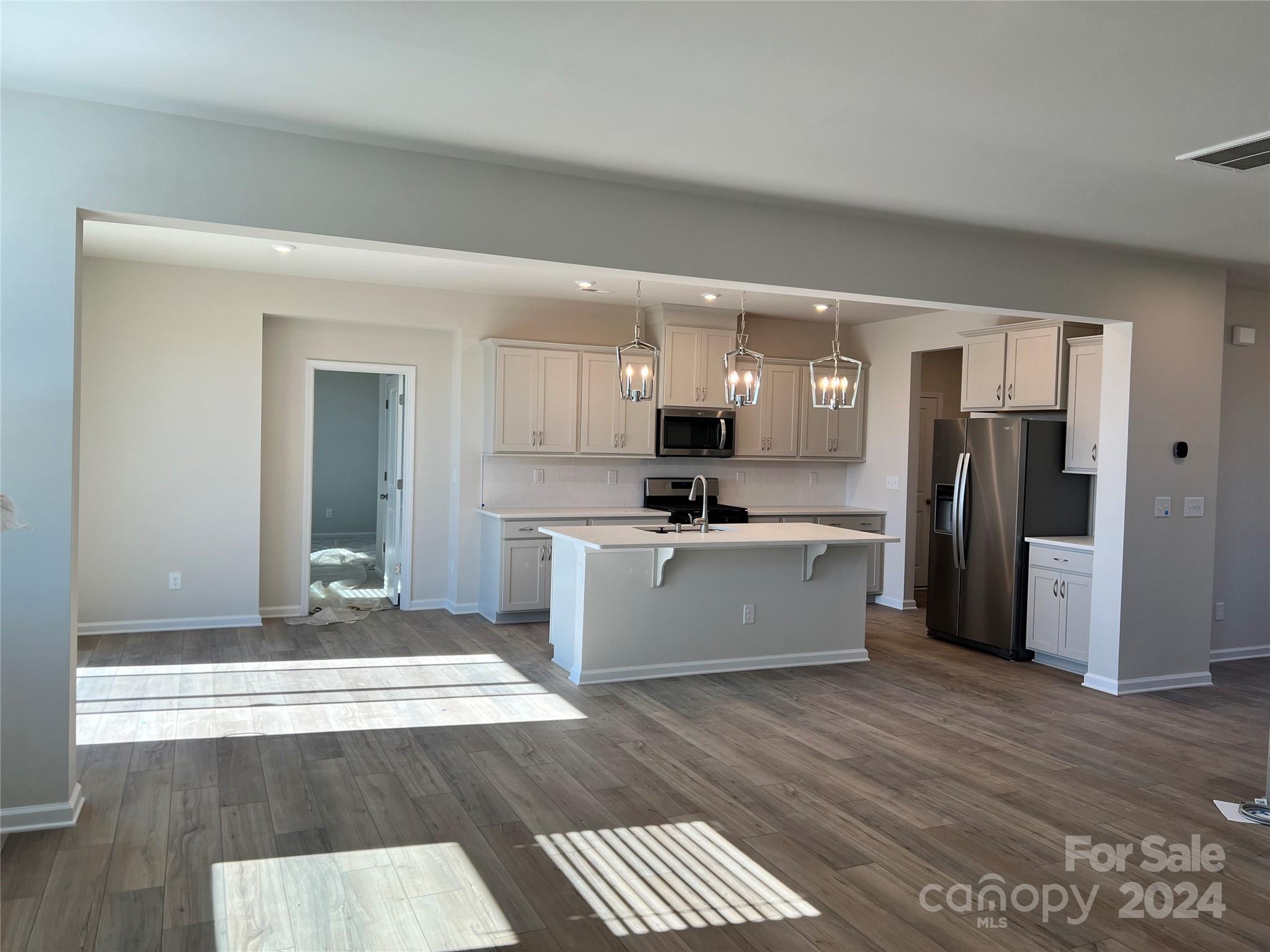 2541 Crimson Way Monroe, NC 28112 - Photo 6 of 22 a large kitchen with a refrigerator a sink and a stove top oven