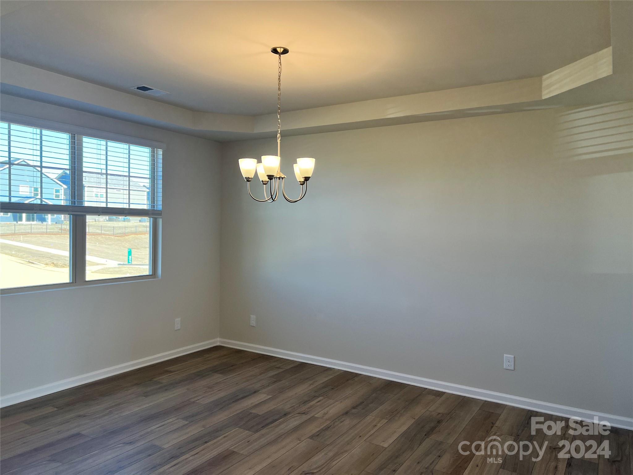 2541 Crimson Way Monroe, NC 28112 - Photo 8 of 22 wooden floor in an empty room with a window