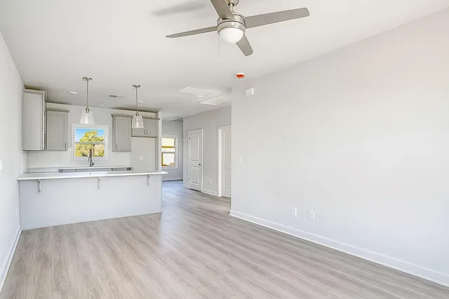 a kitchen with a wooden floor and window