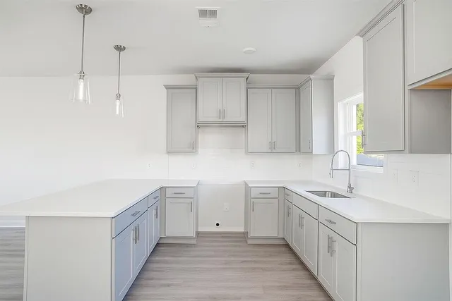a kitchen with white cabinets appliances and a sink