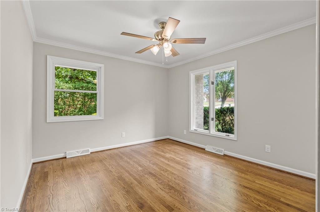 5902 Siler Road Greensboro, NC 27406 - Photo 26 of 49 Bedroom #2 with beautifully refinished hardwood floors. New interior paint throughout the home. No more popcorn ceilings!